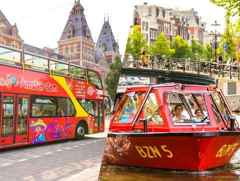 Hop-on hop-off Amsterdam sightseeing bus at a canal side stop